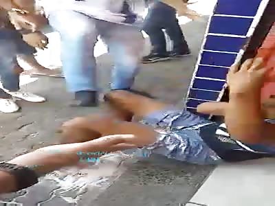 Young cell phone thief beaten in the street.
