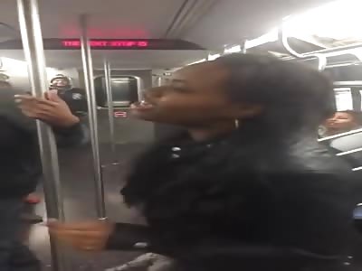 A man hits a woman in the New York underground.