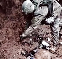 Ukrainian soldier is seen digging out Russian body
