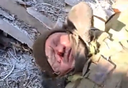 UA soldier shows a dead RU body after taking over a position