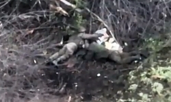 A RU soldier looting the corpse of another RU soldier