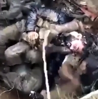 Ukrainian pissing on Russian corpses