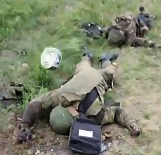 A UA soldier throws a Russian can of meat at a dead ORC