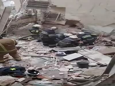 Firefighters Remove Victim from Rubble