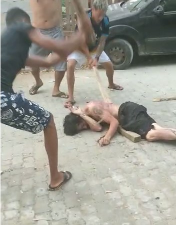 thief lying down really beaten with slats Round