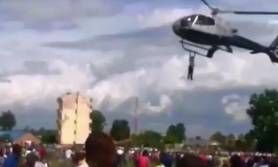 Crazy Guy from Kenya decides to Hold onto the Helicopter as it Takes off 