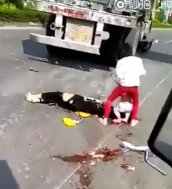 A Sad Scene..Daughter Works on her Mother in Gory Aftermath with Little Child on the Street 