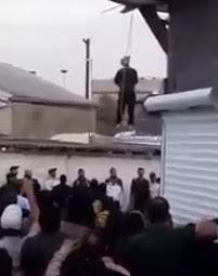 Man being hanged to death in front fanatic crowd