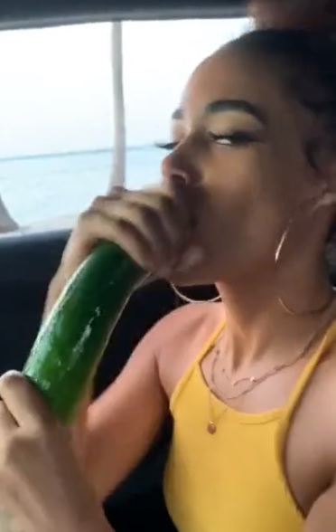 A women eating a cucumber