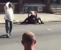 Woman is beat in the Street. Everyone stands around Watching! 