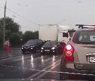 Woman Walking in Traffic During Rain Storm is Struck By Truck