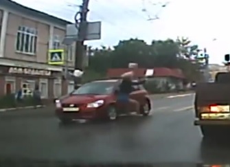 Woman Crossing Street is Flown by Car