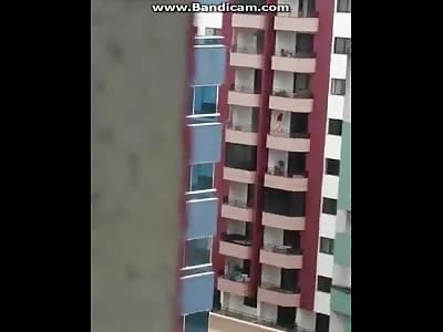 women jump from building 