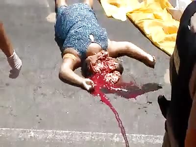 Dead woman with her head crushed by a bus
