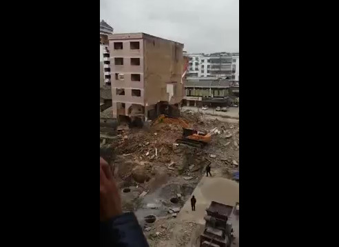 Worker in Escavator Crushed by Falling Building