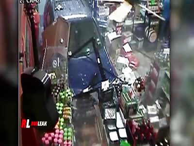 CAR CRASHES THROUGH STORE AND WOMAN IS INJURED