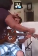 MAN BEATING BY WOMAN AS HE WAS PLAYNG MUSIC FOR EX-WIFE