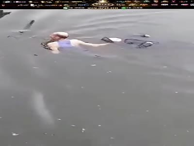 BODY BEING REMOVED FROM WATER