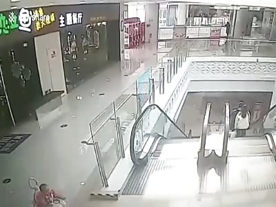 MAN RUNS TO RESCUE INFANT FALLING DOWN AN ESCALATOR