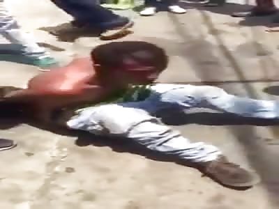 TIED THIEF IS BEATEN BY MOB