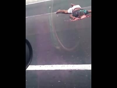 CRUSHED MAN LYING ON THE ROAD