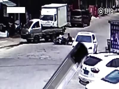  Passenger run over by car after scooter is hit by reversing Truck.