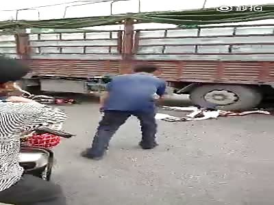  Woman with body under truck wheel asks for Help.