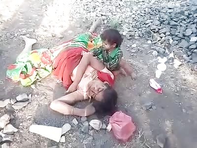 Child takes milk from his dead mother
