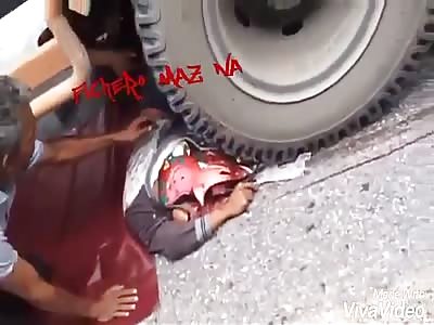 Under a truck with a shattered head