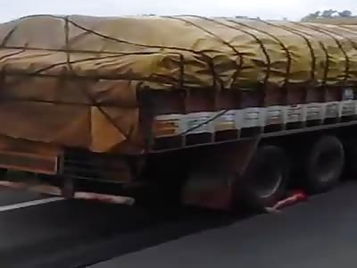 Man crushed by truck guts on the road