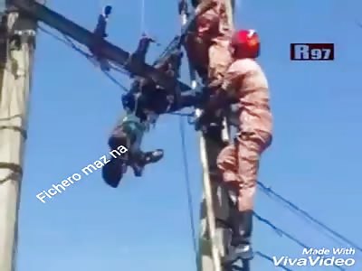 SUICIDE: man commits suicide on light wires and his body is lowered by rescuers