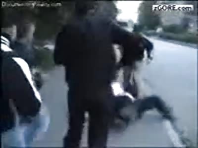 A helpless man is brutally beat by a bunch of young kids no reason 