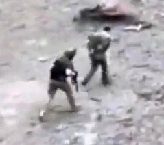 UA soldiers hustle with a ORC POW and shoot into the dirt behind him