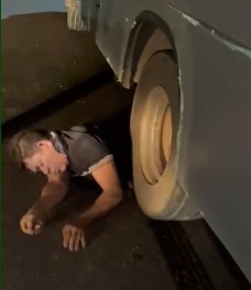 man gets tangled up in truck wheels
