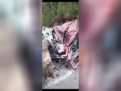 A pickup truck was crushed by a massive rock.