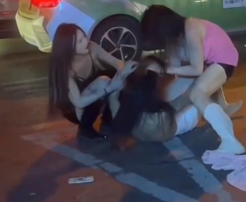 Group of Chinese ladyboy prostitute fighting in street 