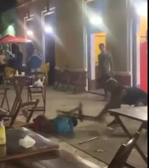 man chased by several passersby beaten with chairs