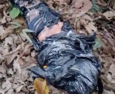 bagged corpse dumped in abandoned road