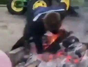 Drunk man bringing wood fall into fire 