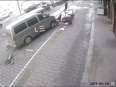 Chinese man grabbing something from his car trunk crashed by van 