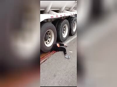 Woman's body completely smeared on the road by tanker truck. 