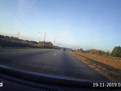 Car hits the back of a truck and causes it to crash killing the driver