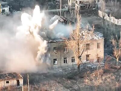 Ukrainian tank is destroying a building with invaders
