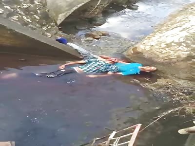 Two Guys in Agony Lying in the Sewer after an Accident