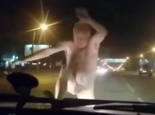Lunatic nude Russian man attack cars in middle of street 