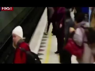 Heart-stopping moment a woman 'in her own world' walks off a train platform