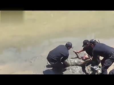 Drunk man found on his back in the mud of a river bank