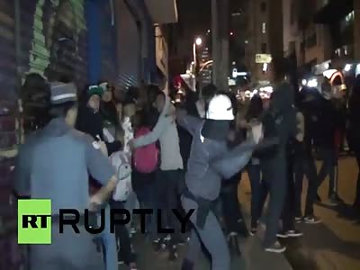 Police batter anti-Olympic protesters with batons in Sao Paulo. 