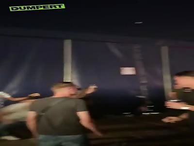 Fight between multiple guys and girls at a festival