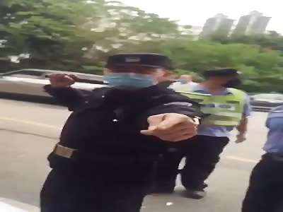 Chinese police assaulting a black man.